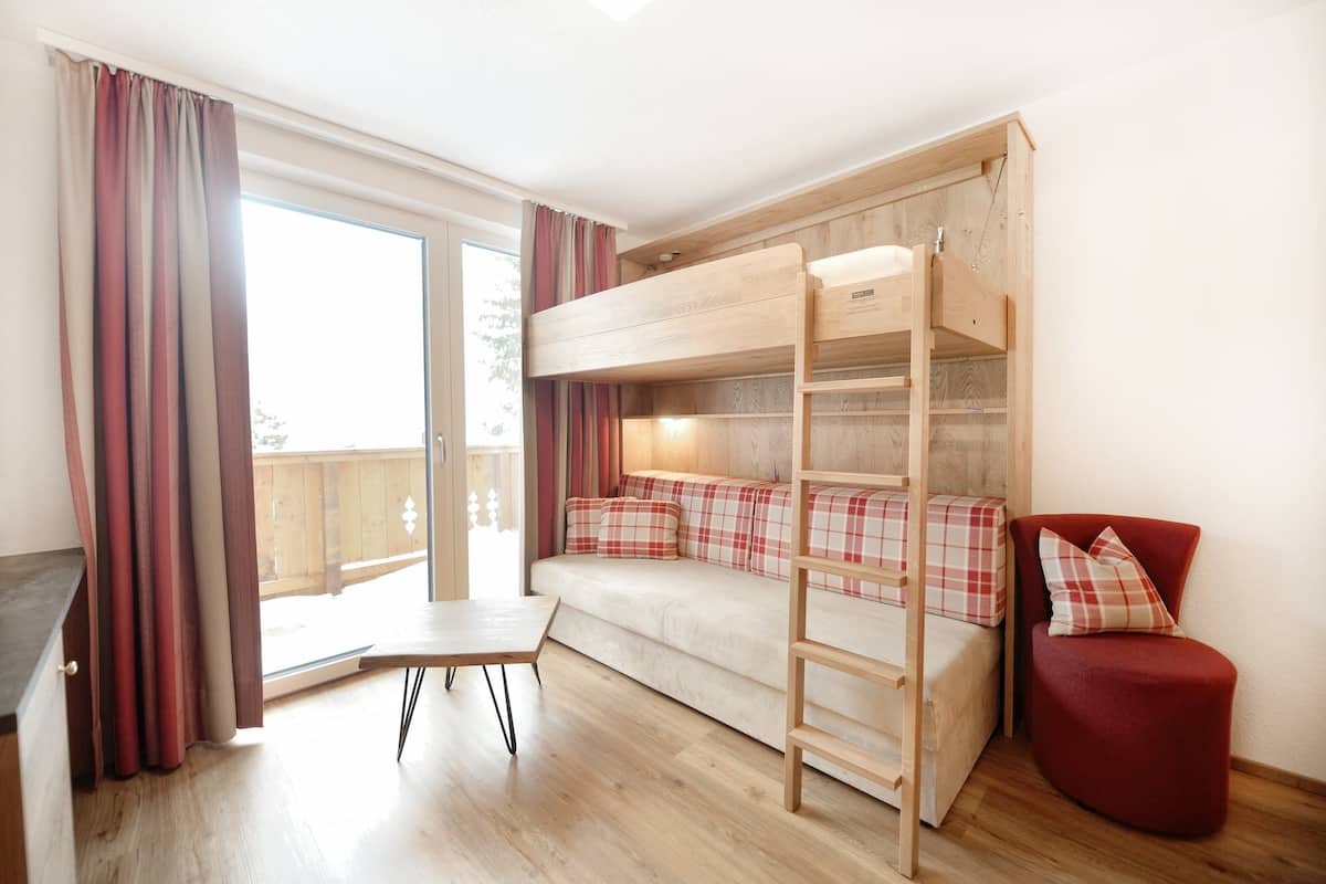 junior suite, balcony, mountain view (valluga) | living area | 49-inch flat-screen tv with cable channels, tv