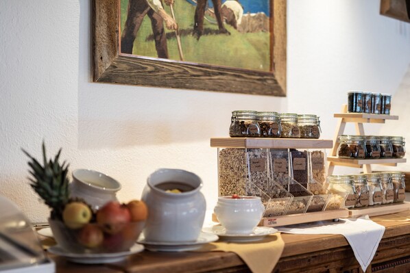 A breakfast buffet with various food items and condiments. - Hotel Alpina Arlberg (Pettneu am Arlberg)
