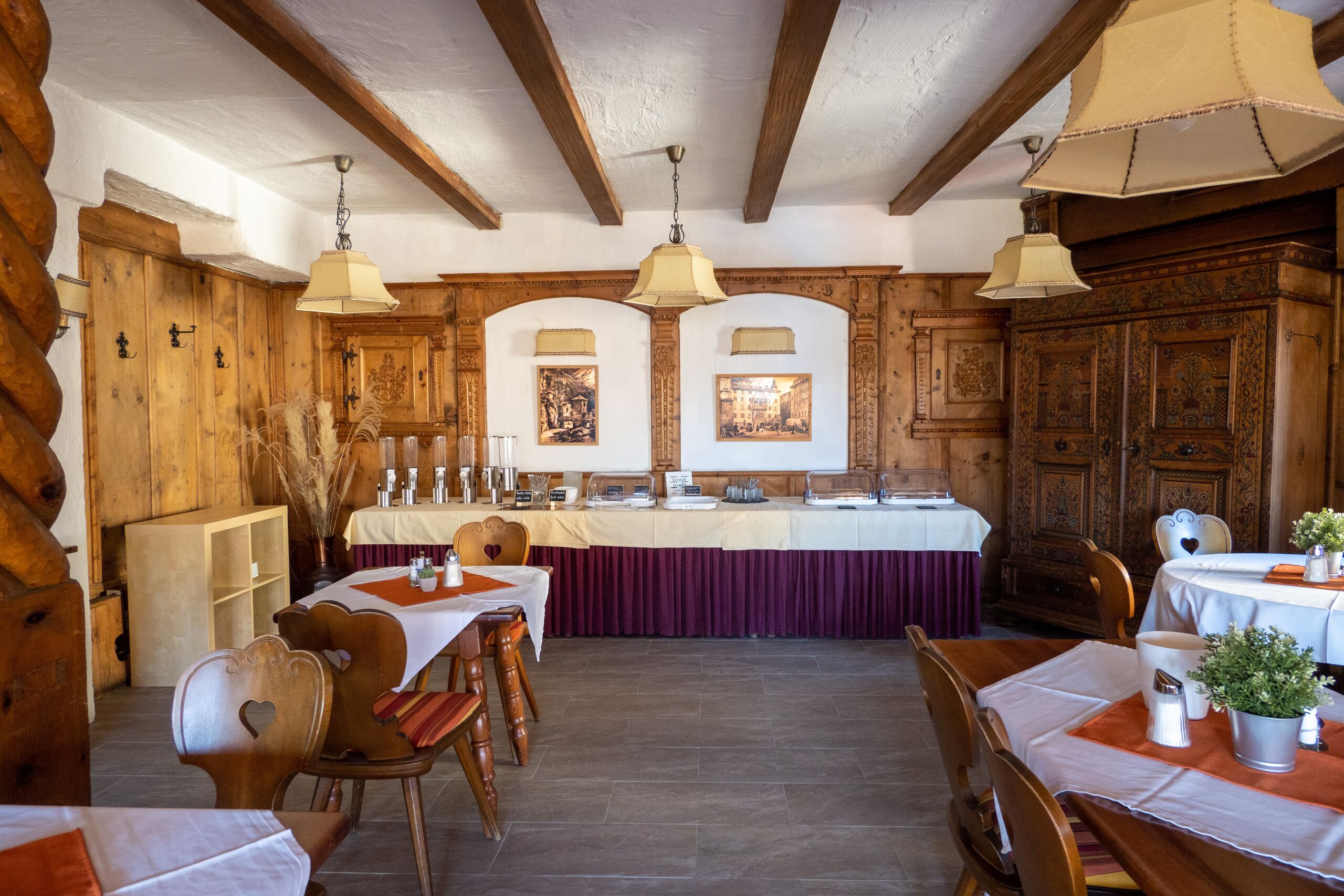 Un comedor rústico con mobiliario de madera, un bufé y decoración tradicional.