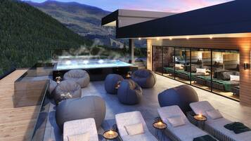 Un área de lounge exterior moderna con asientos y un jacuzzi, con vistas a un paisaje montañoso.