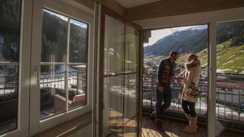 A room with large windows offering a view of a mountainous landscape.