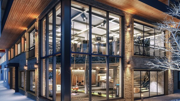 A modern building with large glass windows, a wooden interior, and a snow-covered ground. - Hotel Tirolerhof (Tux)