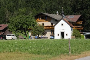 A traditional Alpine building with a sign reading 'Tannenhof.'