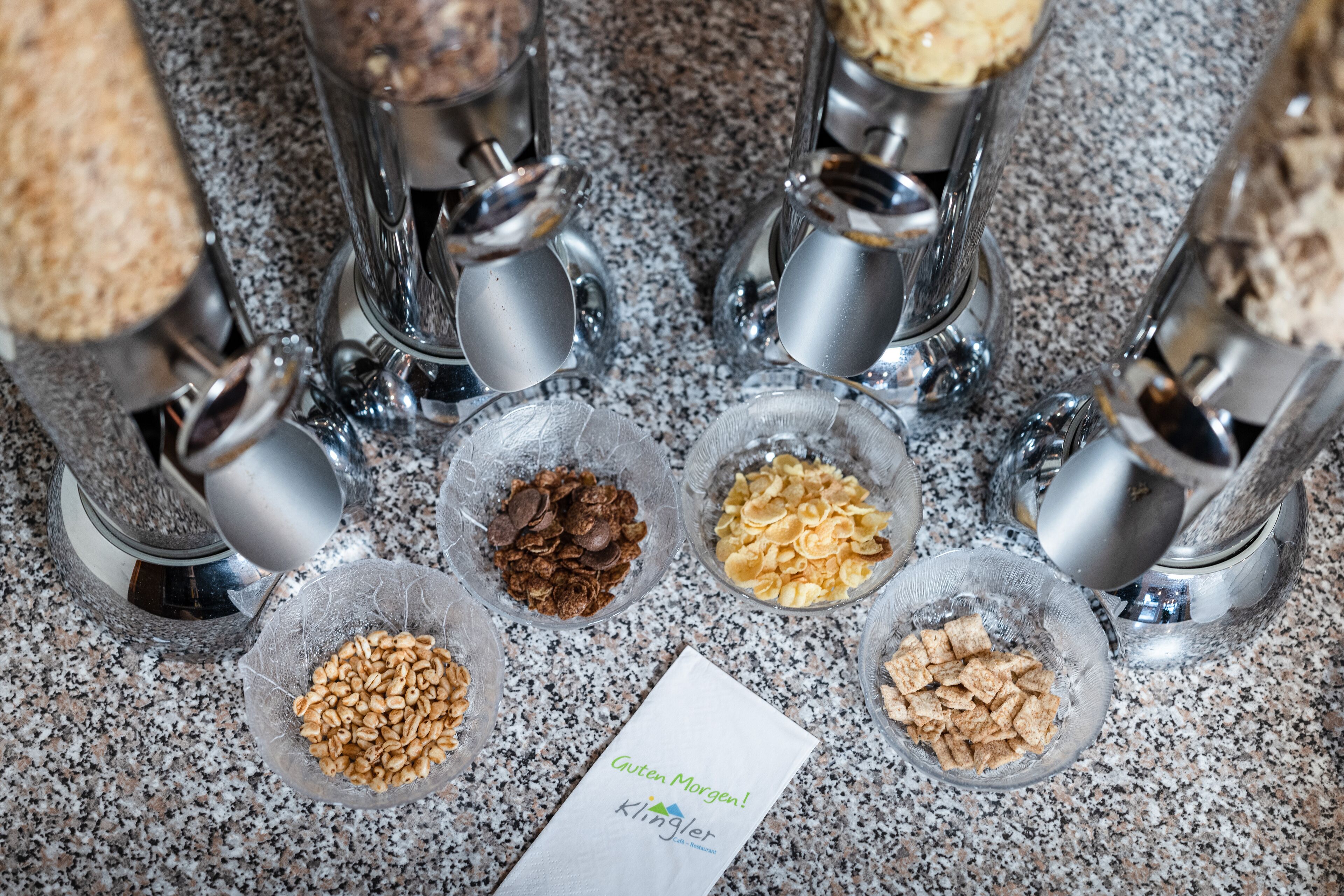 A kitchen counter with various food items in bowls and a paper with text.
