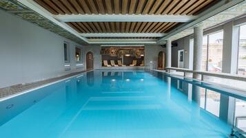 Indoor pool, pool umbrellas, pool loungers