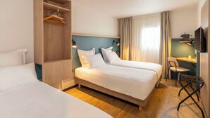 A hotel room with two beds, a desk, a chair, and a wardrobe. - Le Carline, Sure Hotel Collection by Best Western (Caen)