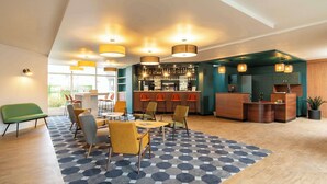 A modern lobby with a bar area, seating arrangements, and a patterned carpet. - Le Carline, Sure Hotel Collection by Best Western (Caen)