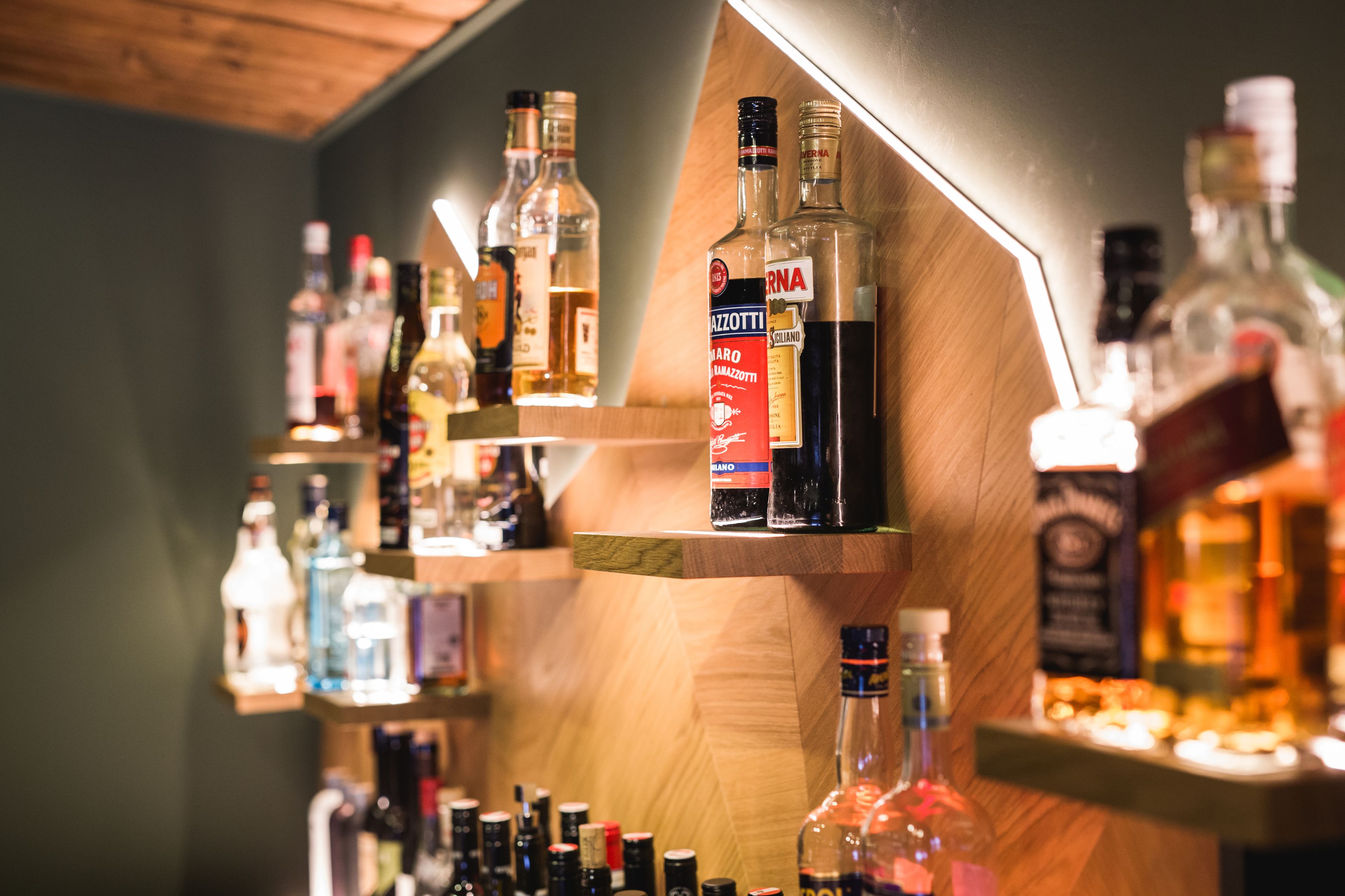 A bar with shelves of various liquor bottles.