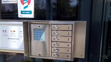 A hotel room's entry system with a keypad and numbered drawers.