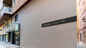Un edificio con un letrero que dice 'Torreluz Centro' en una pared lisa.