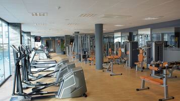 Ein Fitnessstudio mit Laufbändern, Kraftgeräten und Trainingsgeräten.