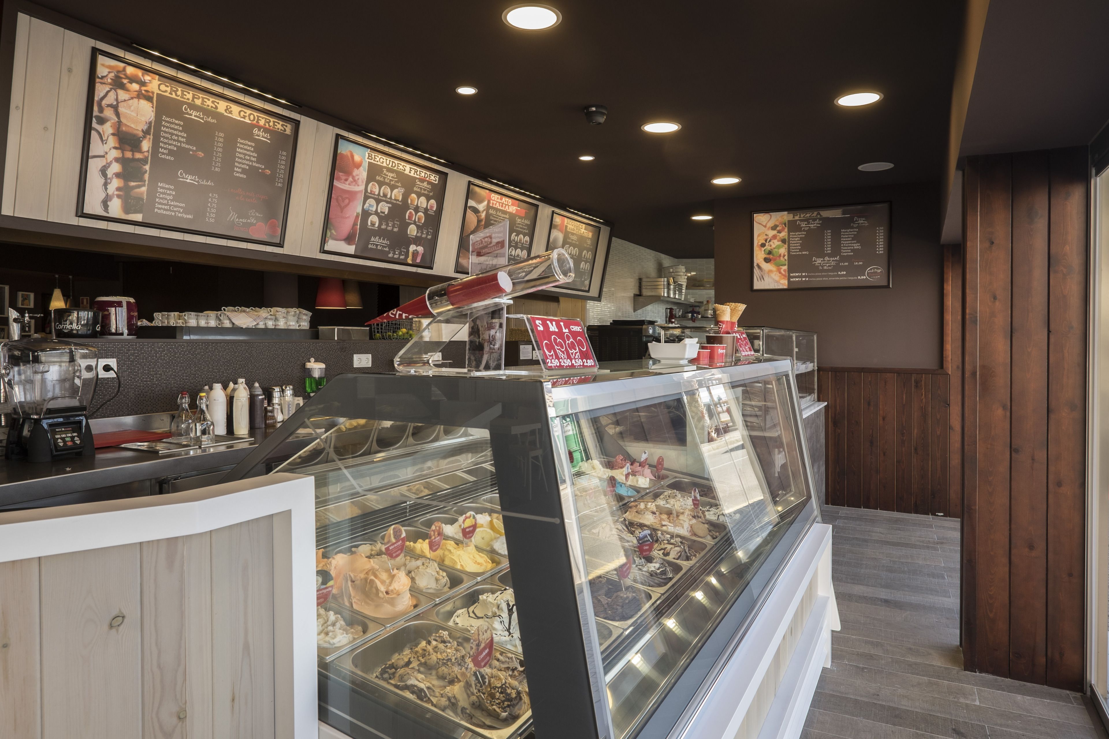Mostrador de panadería con diversas opciones horneadas y un cartel de menú en la parte superior.