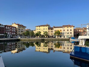 Waterfront homes offer stunning views of the calm body of water and surrounding architecture.