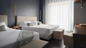 A modern hotel room with two beds, a sitting area, and a large window with curtains. - The Regent Boutique Hotel & SPA  (Borgo Maggiore)