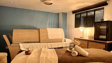 A modern bedroom with a bed, bedside table, lamp, and a television.
