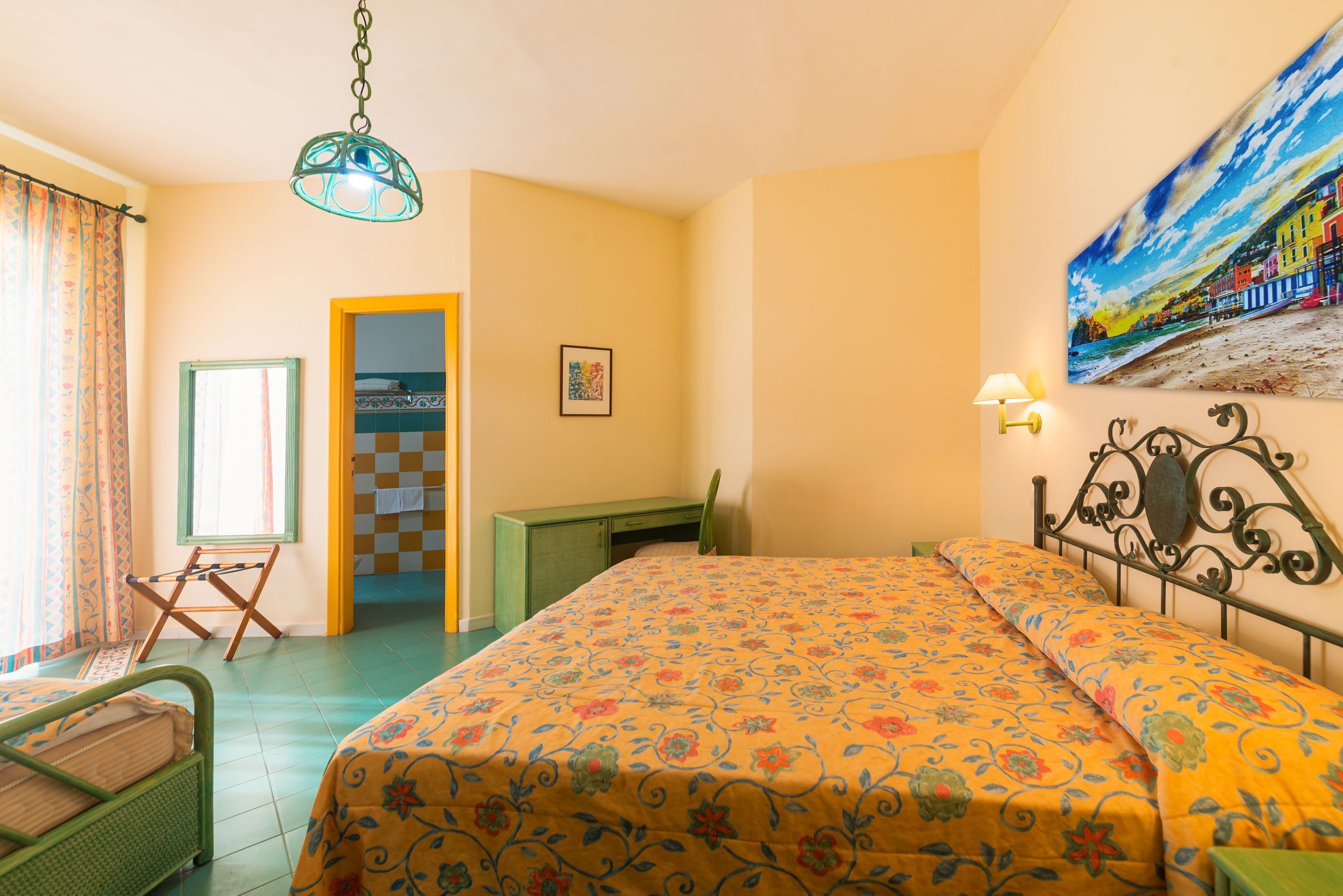 Ein Schlafzimmer mit einem Bett, einem Schreibtisch, einem Stuhl und einem Bild an der Wand.