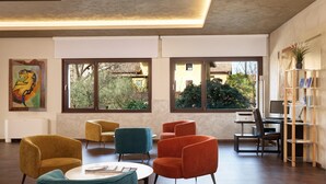 A modern interior with a seating area, a desk, and a bookshelf.