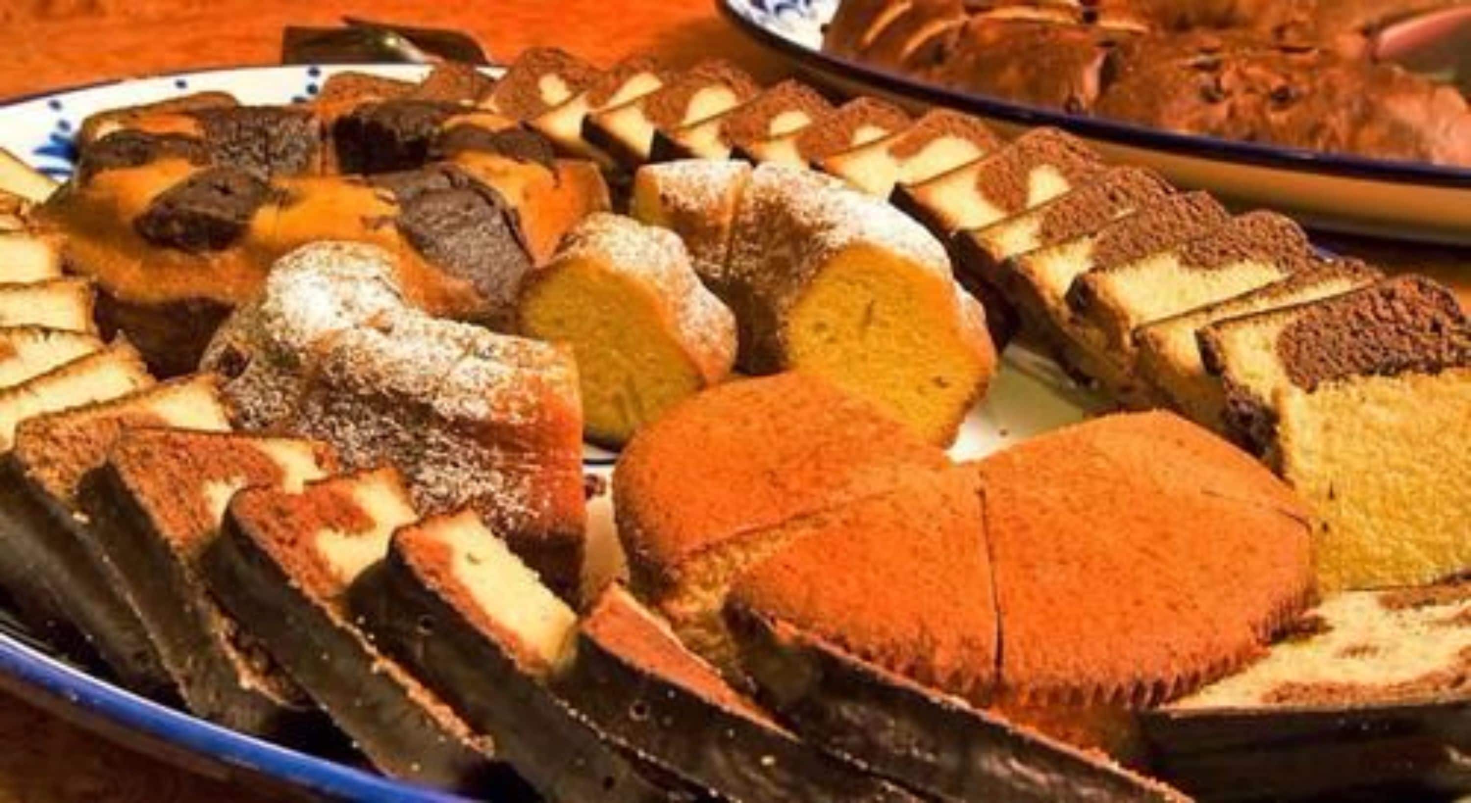 A variety of sliced cakes and pastries on a plate.