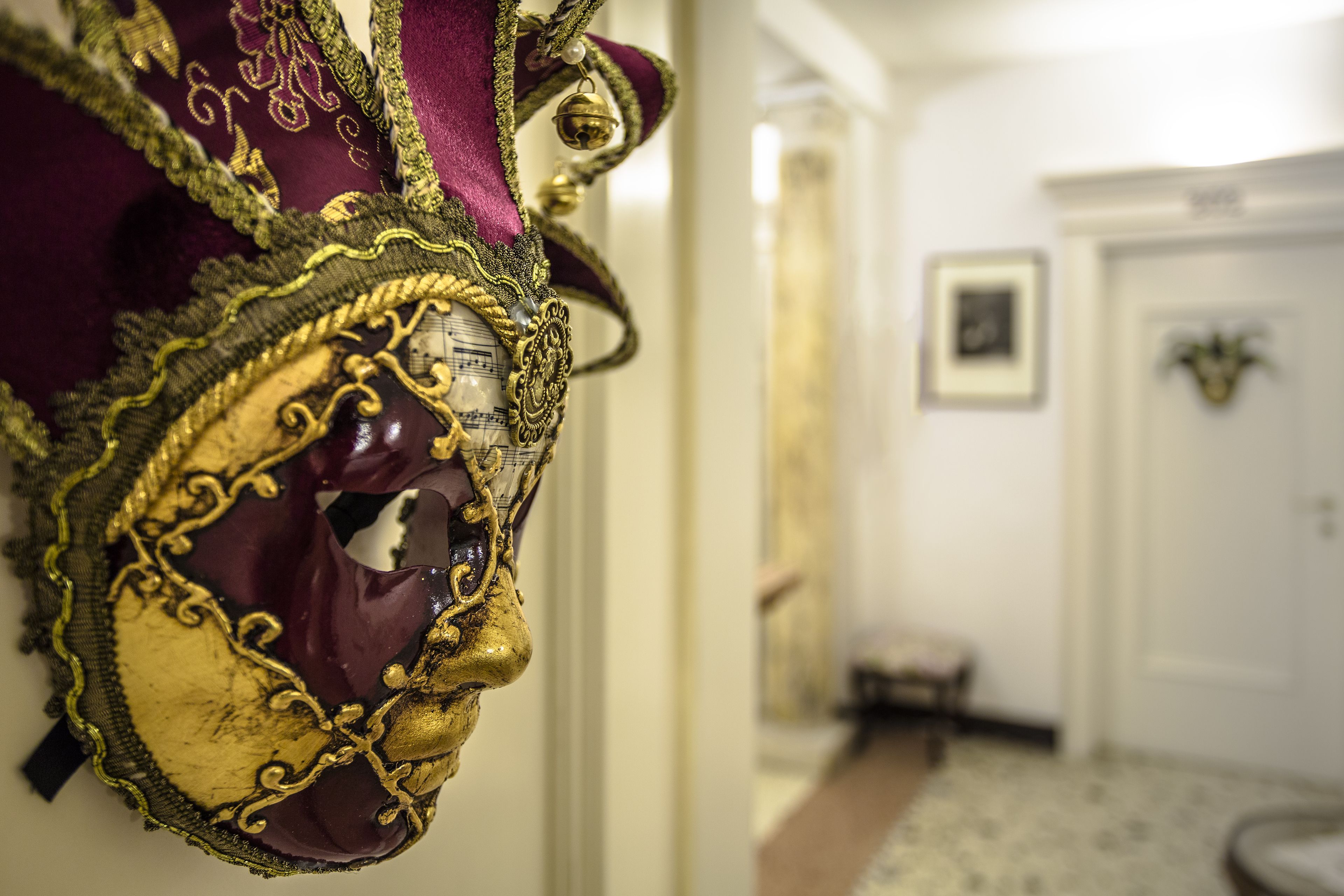 A close-up of an ornate mask with gold and purple details.