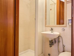 A bathroom with a white sink, a mirror, and a shower area. - B&B Giovy Rome (Rome)