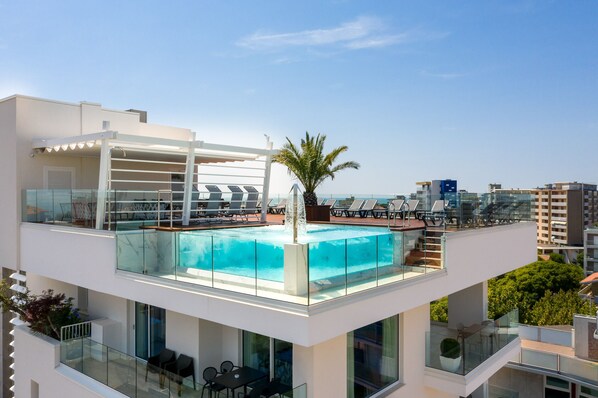 Seasonal outdoor pool, open 9:00 AM to 9:00 PM, pool umbrellas