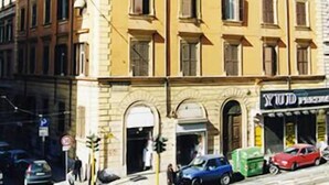 A multi-story building with a classical architectural style, featuring a symmetrical facade with evenly spaced windows and a central entrance. - Rudy B&B (Rome)