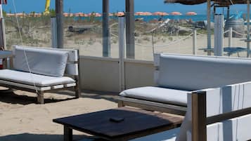 On the beach, white sand, sun-loungers, beach umbrellas