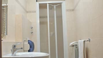 A bathroom with a sink, toilet, and shower.