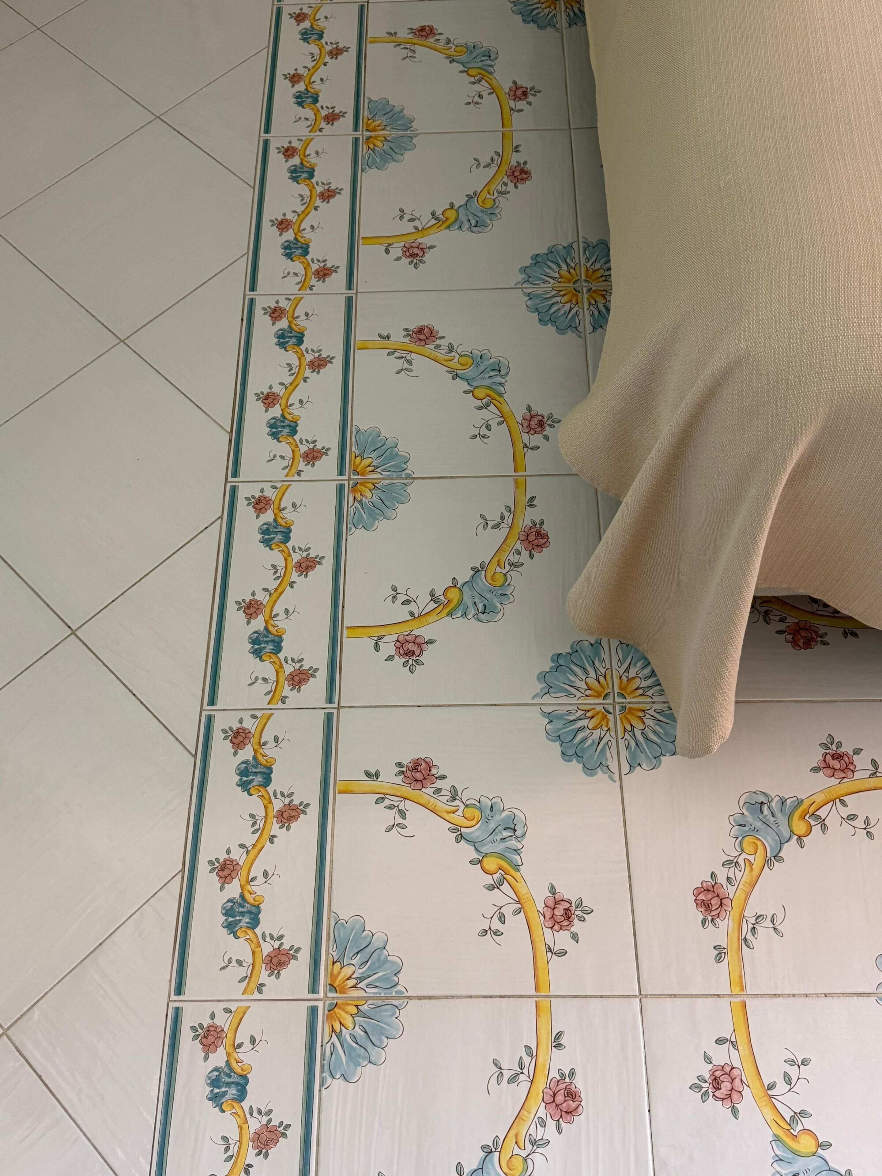 A tiled floor with a floral pattern.
