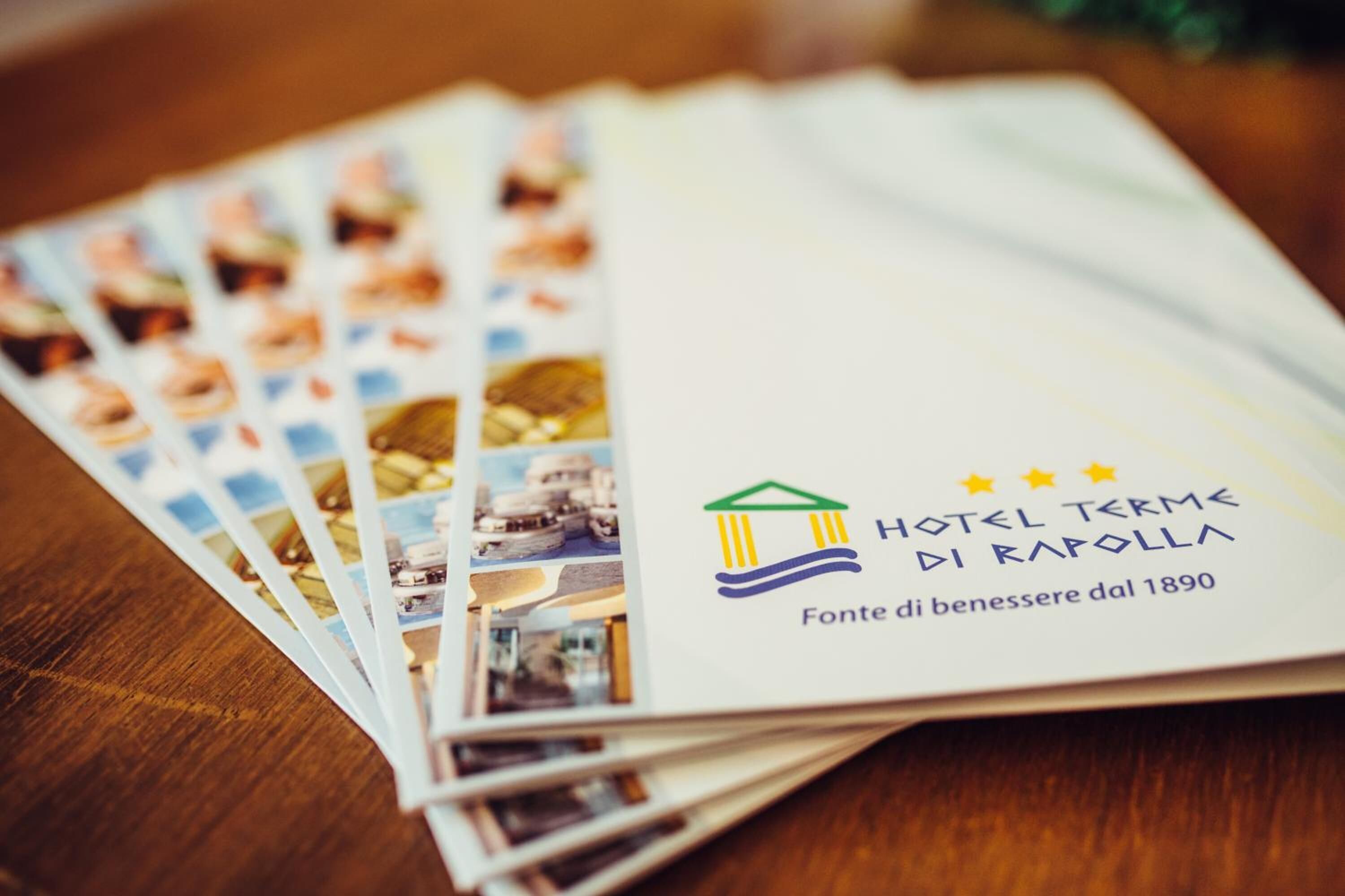 A brochure for Hotel Termini Di Roma featuring a classical building logo, a photo of a historic building, and the text "Fonte di benessere dal 1890".