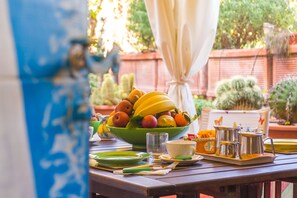 A table set with a fruit bowl, cups, and utensils. - Orchid Corner (Meta)