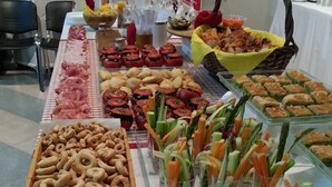 A buffet table with various food items including meats, vegetables, and pastries. - Il Girasole (Milan)