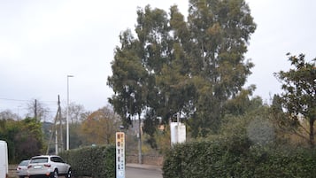 A parking area with a sign indicating a hotel.