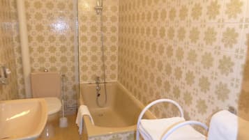 A bathroom with a bathtub, a sink, a toilet, and a shower.