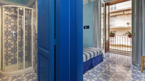 A room with a bed, a wardrobe, and a balcony with plants. - Casa Astarita (Sorrento)