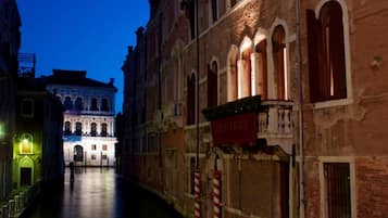A narrow canal with buildings on either side, one with a sign that reads 'CATHEDRAL.'