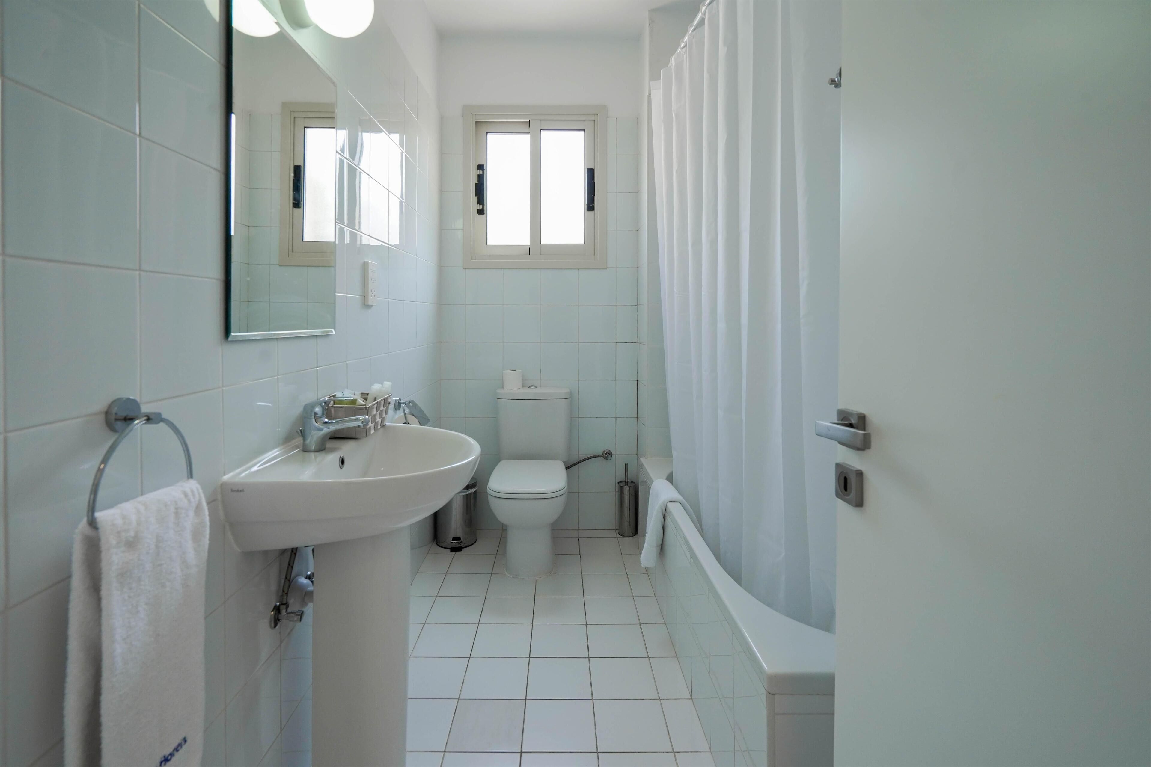 Un bagno con lavandino, WC e vasca da bagno.