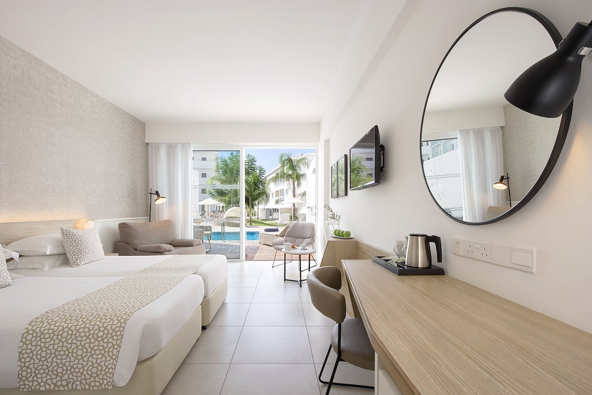 standard double or twin room, pool access | 1 bedroom, in-room safe, individually decorated, desk