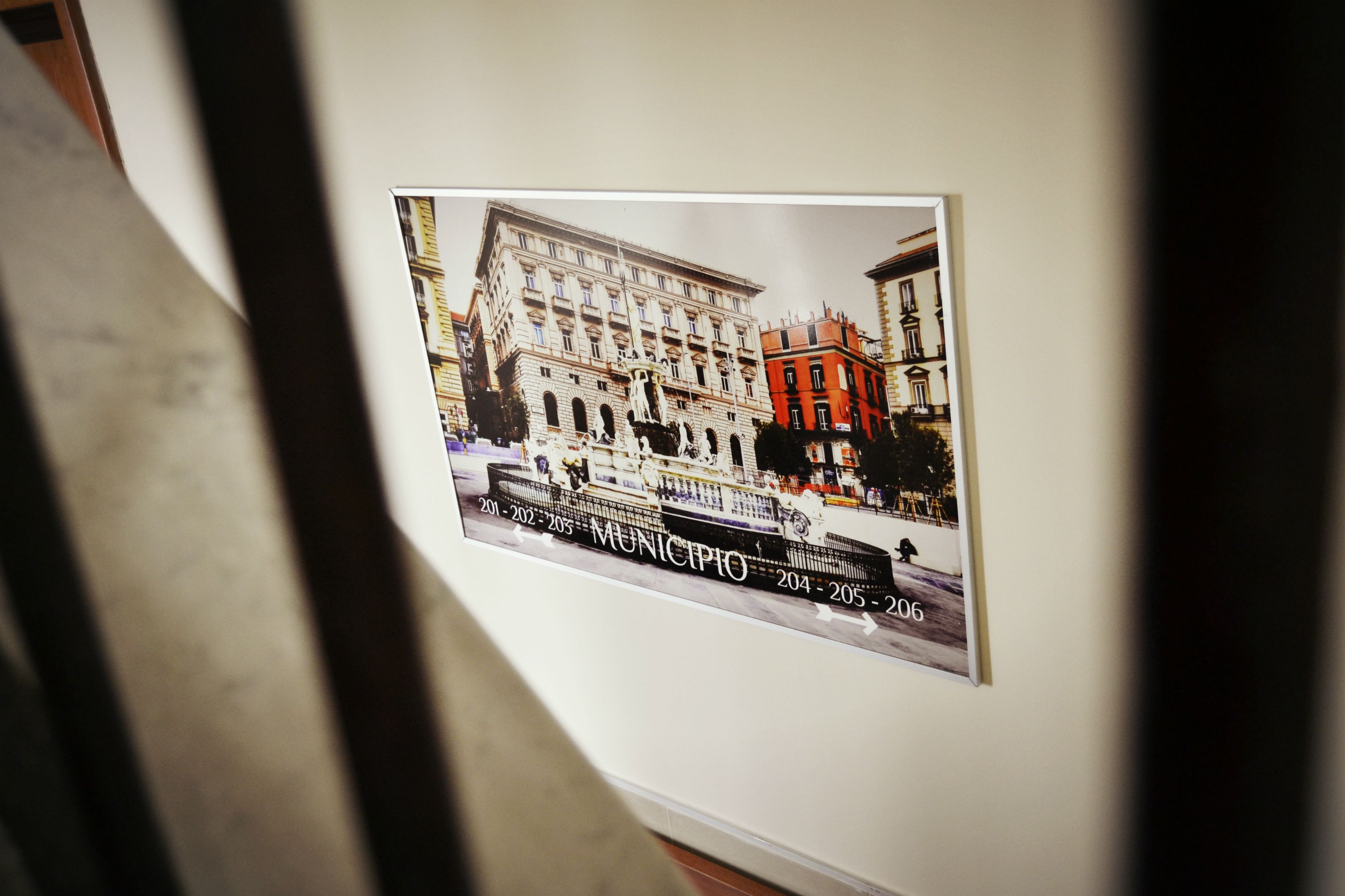A framed photograph of a historic building with a plaque indicating the years 2011-2026.