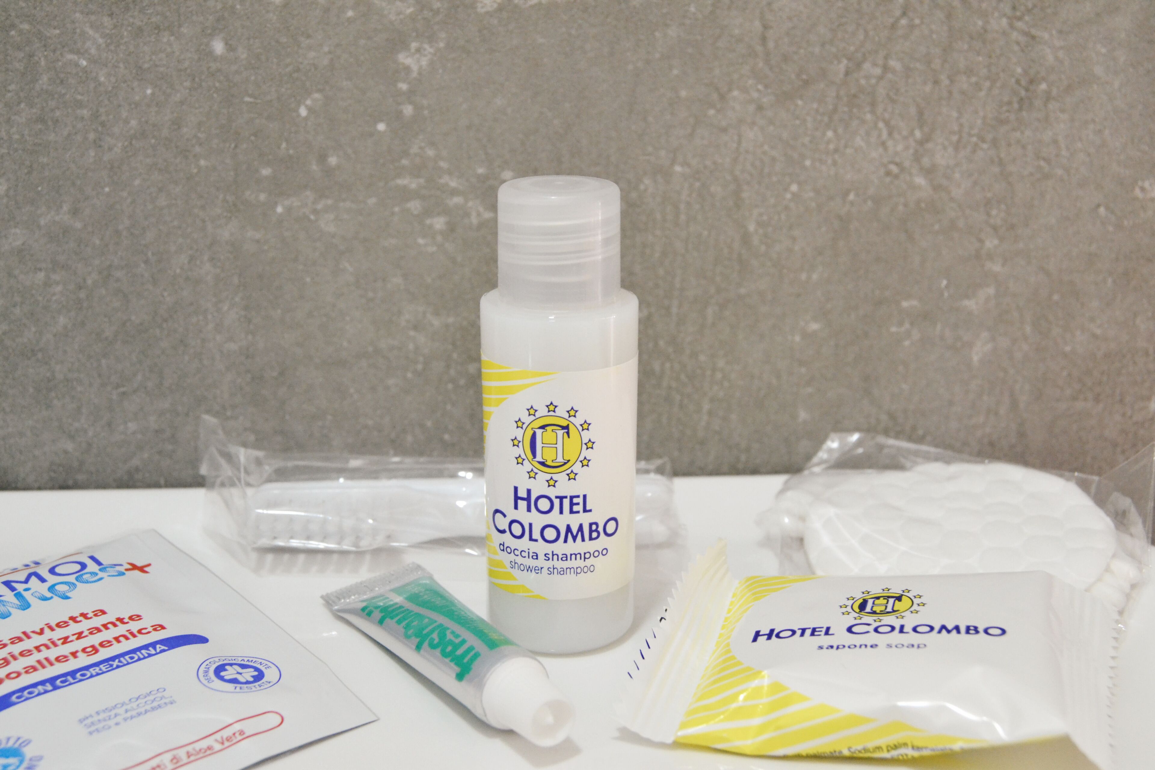 Toiletries including a shower shampoo bottle, a soap bar, a toothbrush, and a toothpaste tube.
