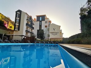 A hotel named Santa Cruz Village with a swimming pool.