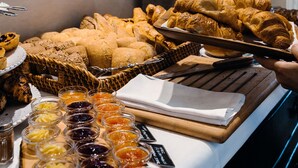 A buffet table with various pastries and spreads.