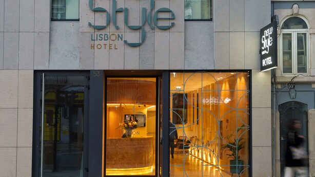 The exterior of the New Style Lisbon Hotel with a modern design, large glass entrance, and a visible reception area inside. - New Style Lisbon Hotel  (Lisbon)