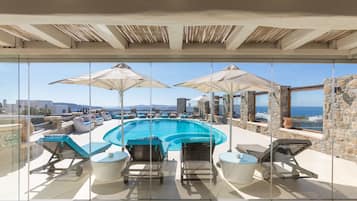 Seasonal outdoor pool, open 9:00 AM to 8:00 PM, pool umbrellas