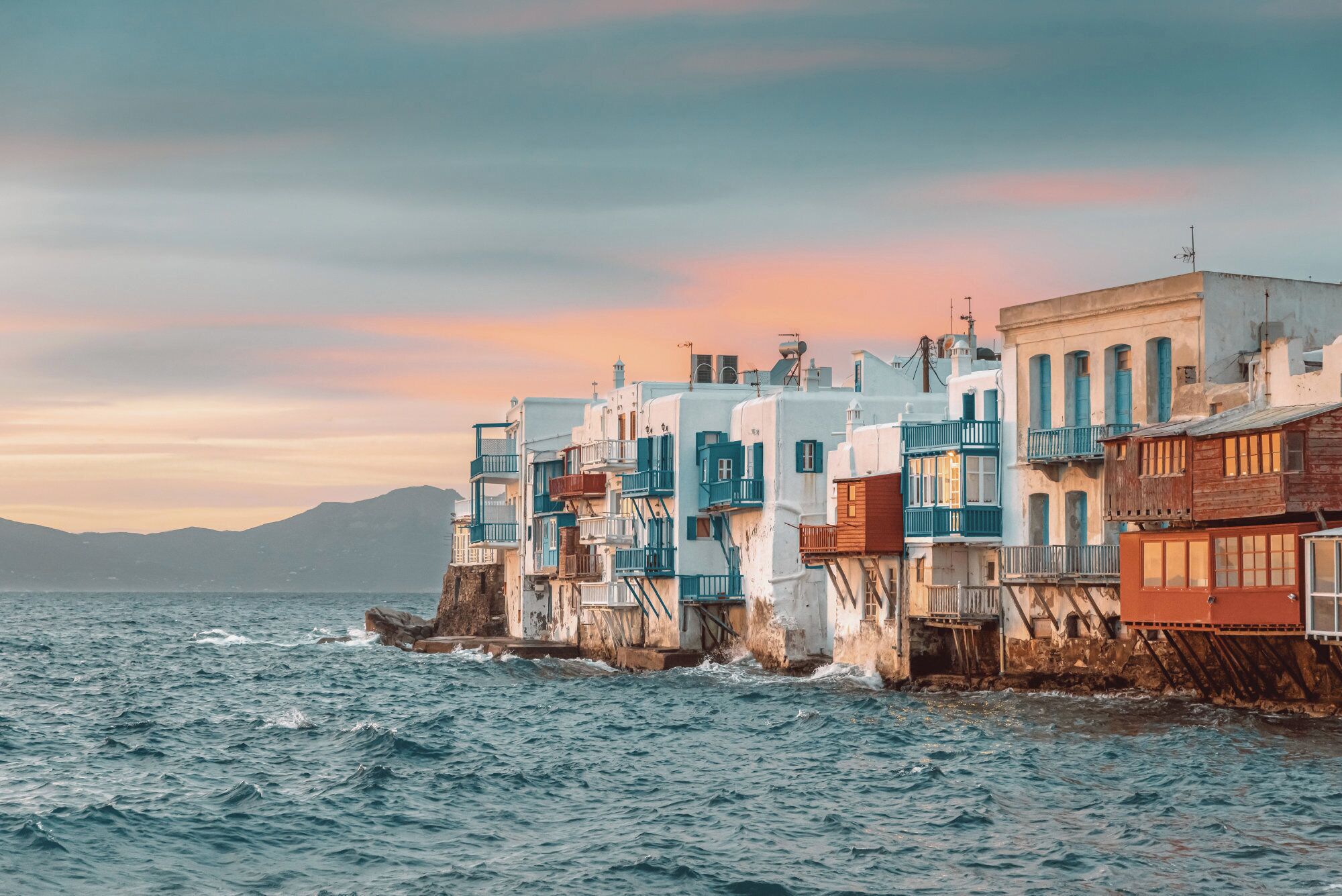 A coastal town with buildings built on stilts over the water.