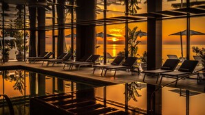 A pool area with lounge chairs and umbrellas, overlooking a sunset view. - Grand Hotel Brioni Pula A Radisson Collection Hotel (Pula)