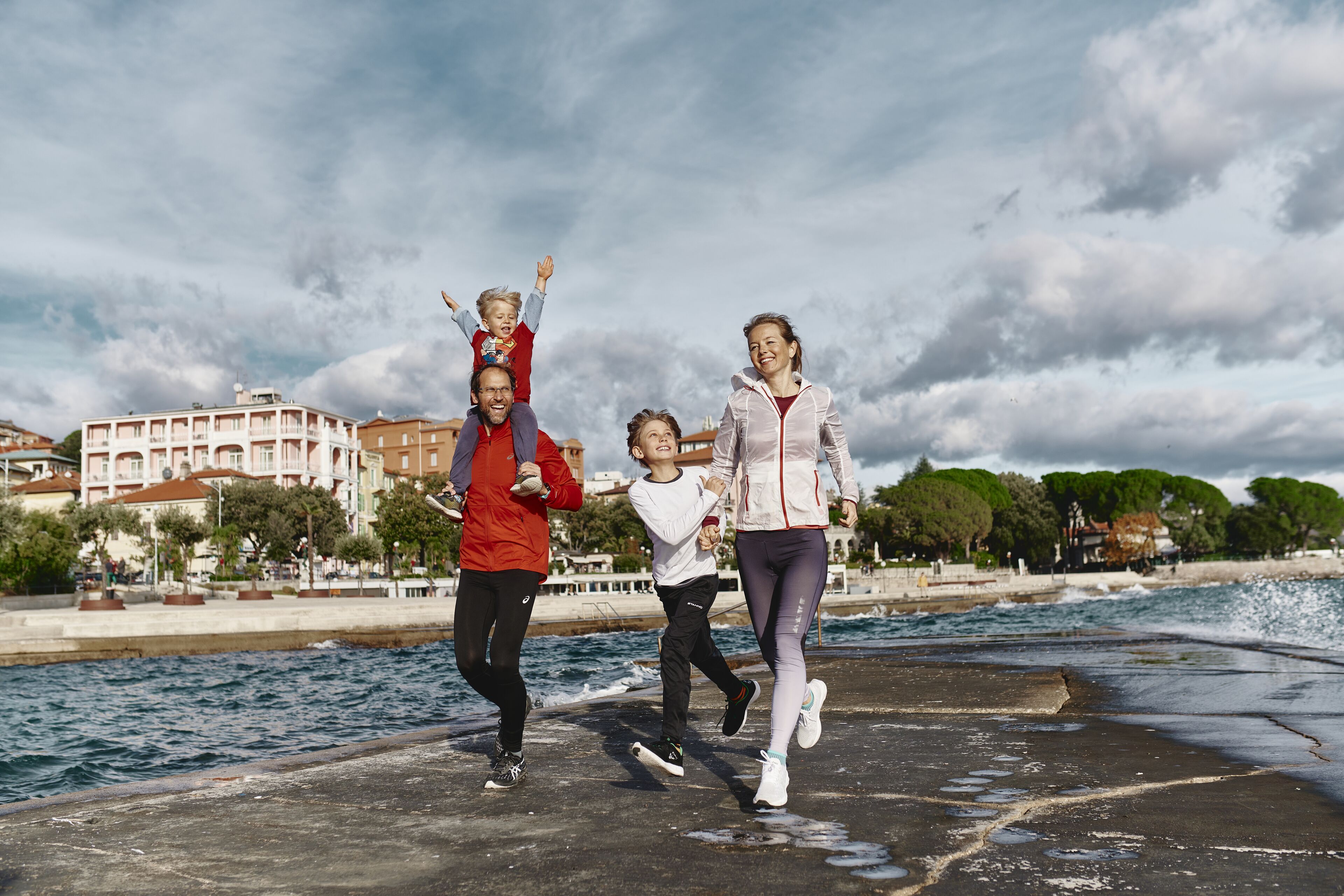 A waterfront promenade with a family walking.