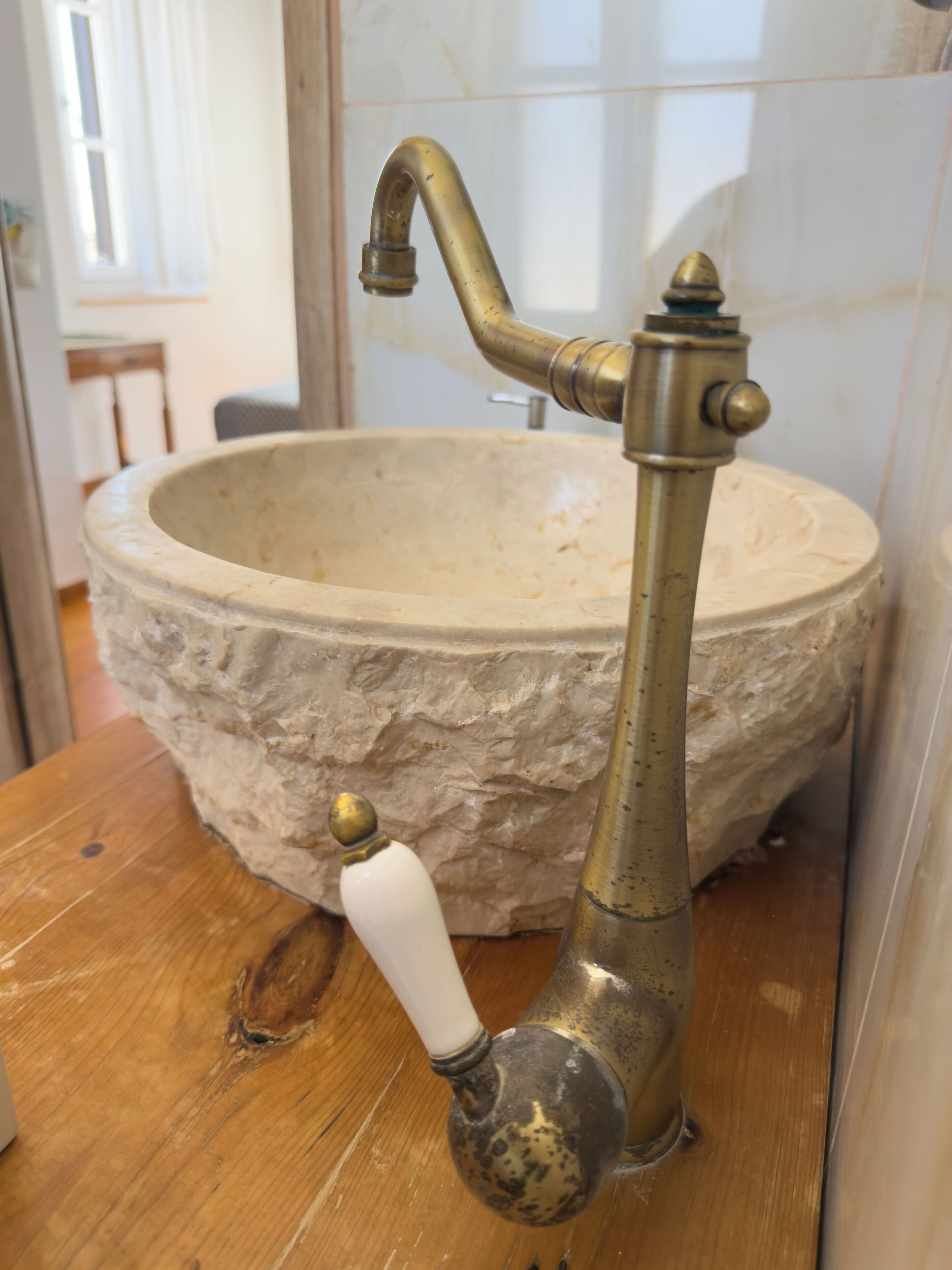 A stone sink with a vintage faucet.