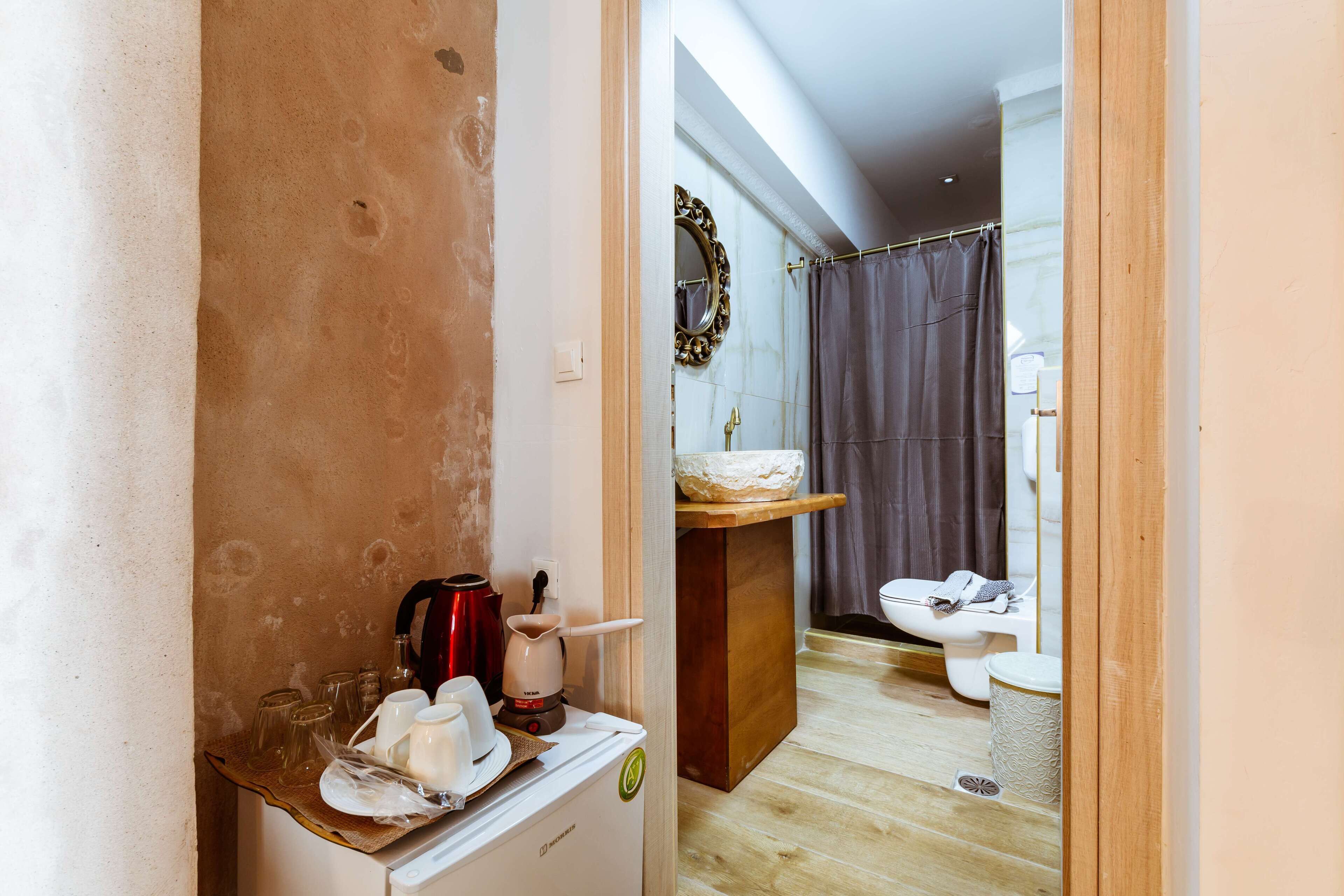 A compact bathroom with a shower, toilet, and sink.