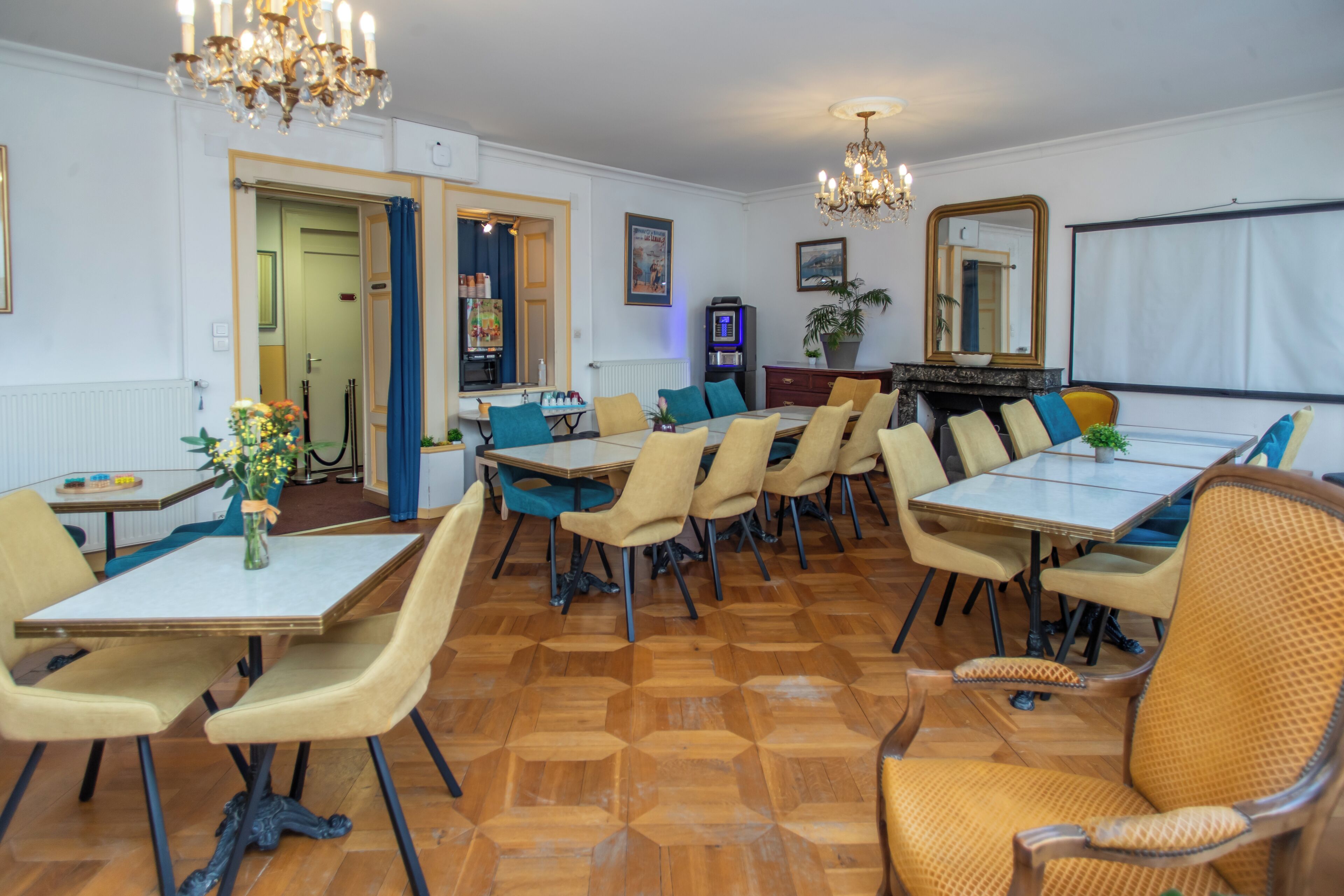 A dining area with a large table, multiple chairs, and a chandelier.